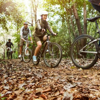 group-friends-ride-mountain-bike-forest-together